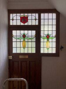 House front door with stained glass above and beside